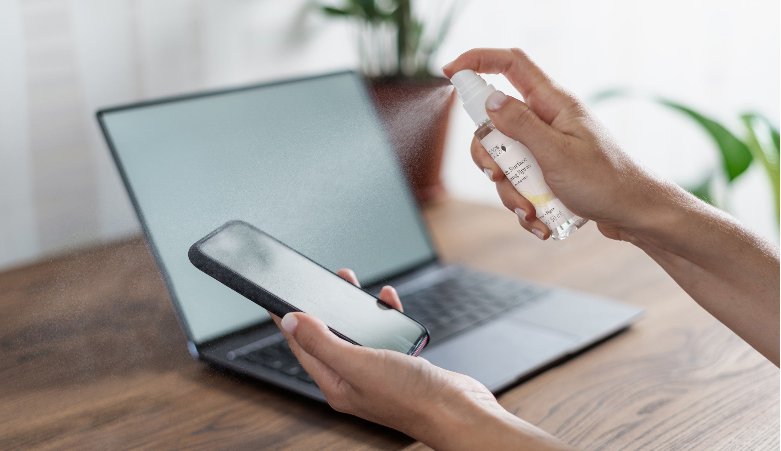 Hand + Surface Spray being used on a home office 