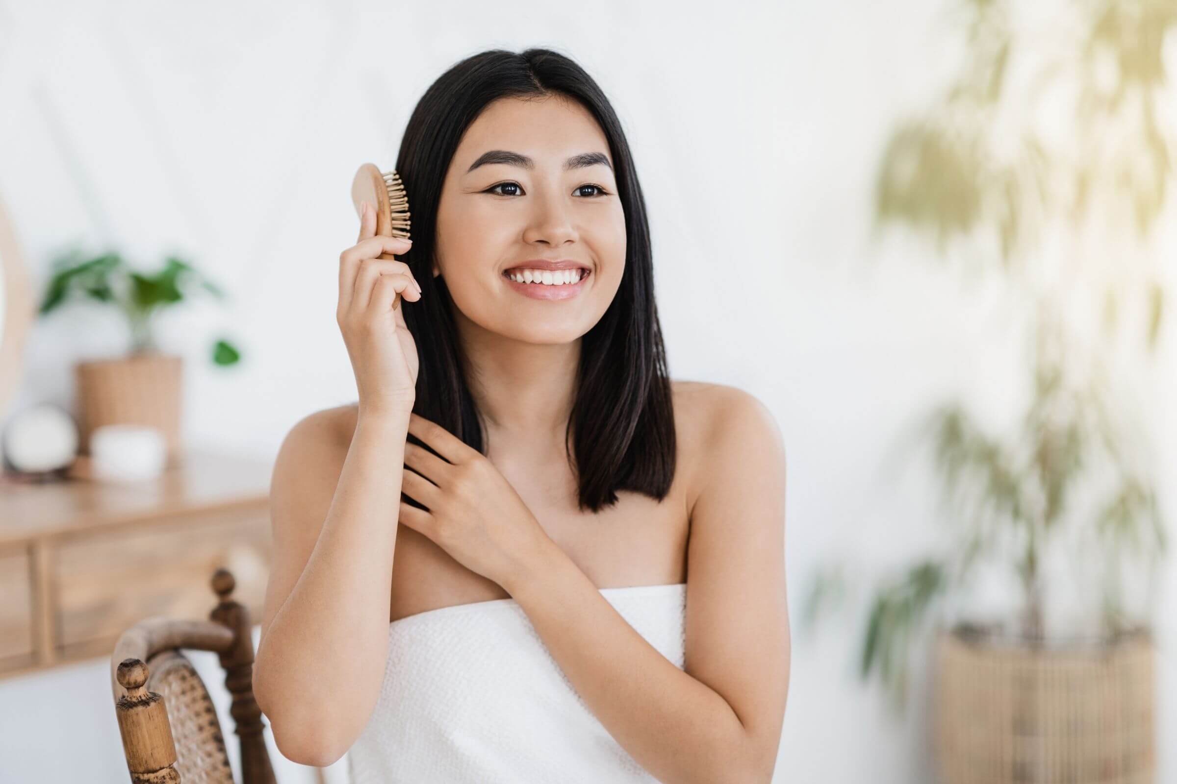 Woman brushing her healthy and soft hair