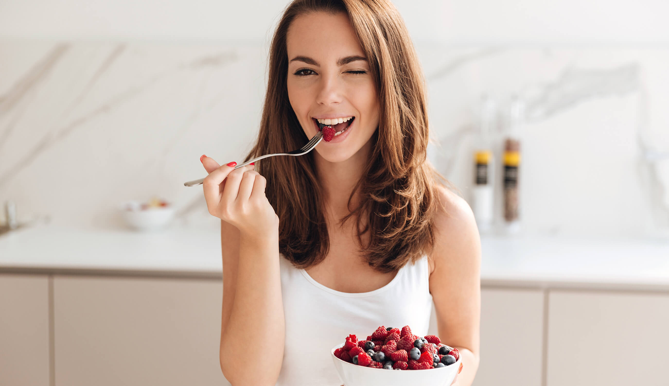 Woman eating from a bowl of berries