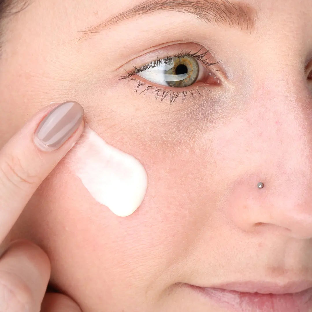 Woman applying 100% PURE Mattifying Primer on face
