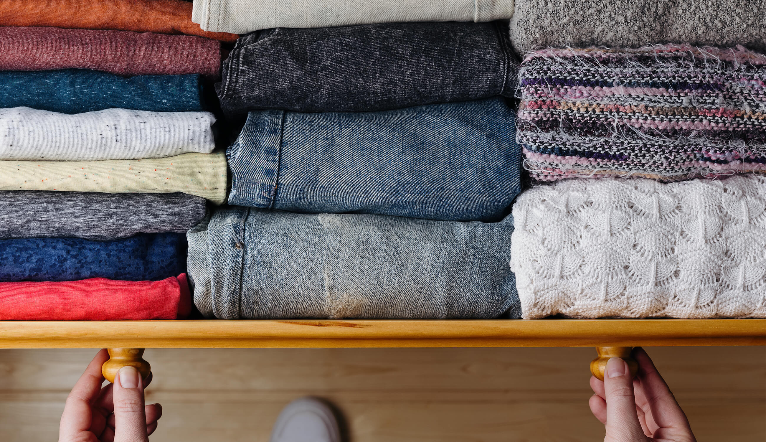 Faded, eco-friendly looking clothes folded in a drawer.jpg