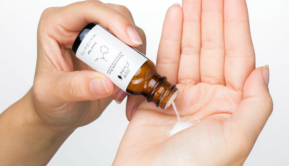 100% PURE Niacinamide Boost poured into hand