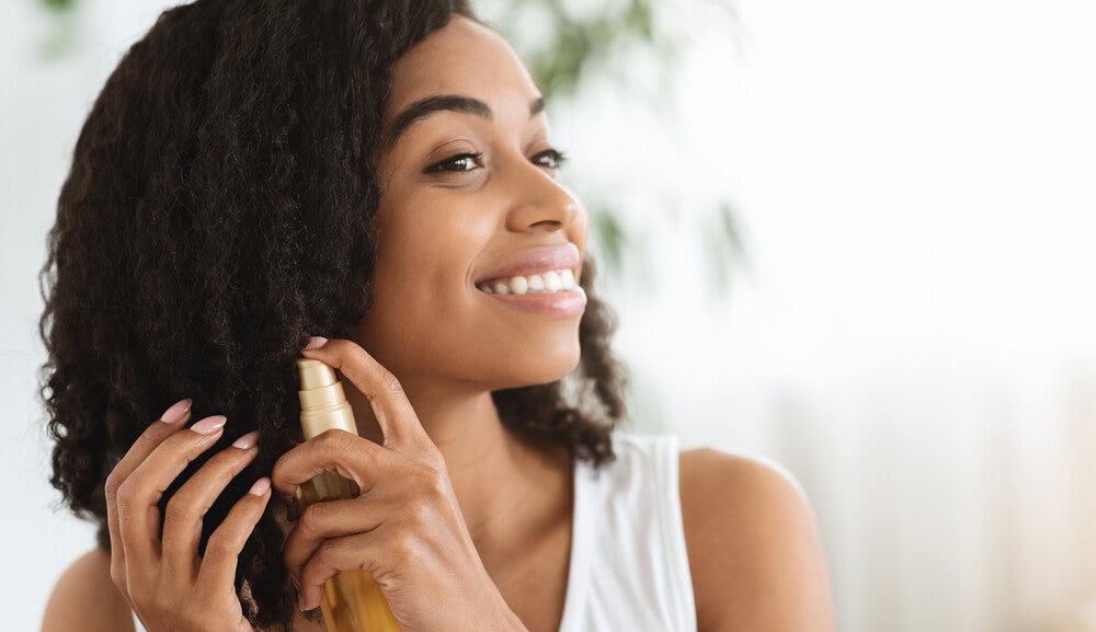 girl applying hair oil.jpg