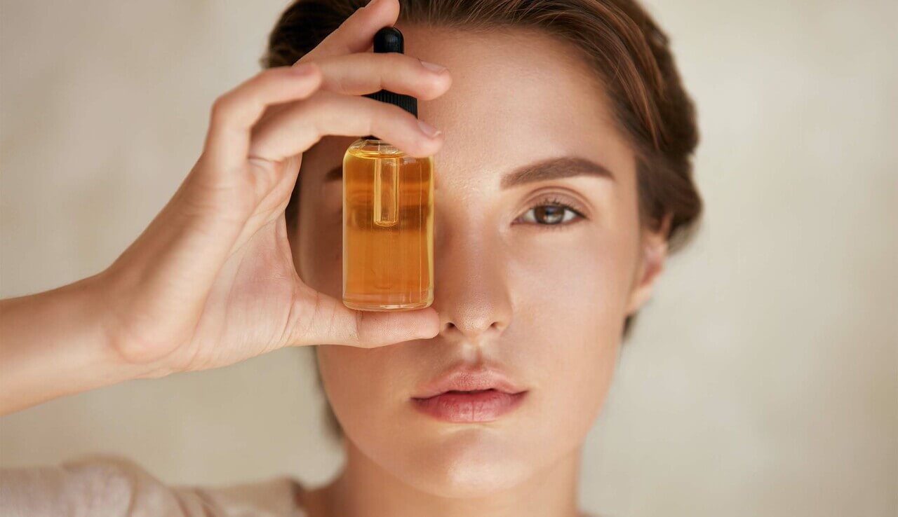 main_Woman with bottle of essential oil.jpg