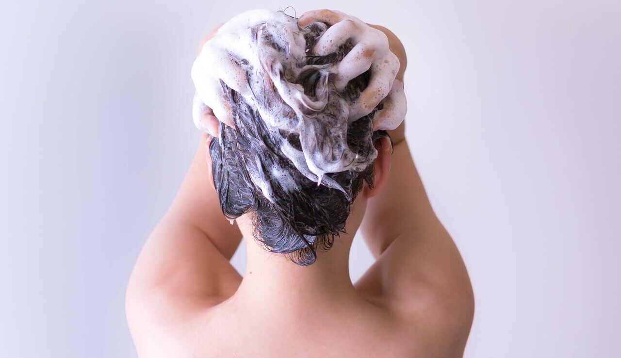 Main_woman scrubbing scalp with shampoo.jpg