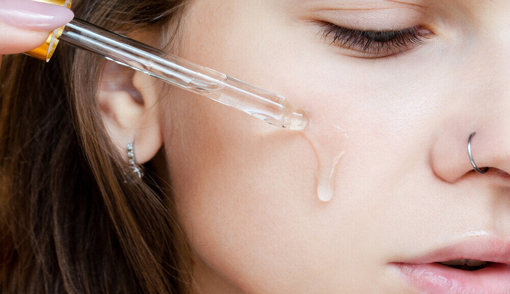 Main_woman uses serum for face.jpg