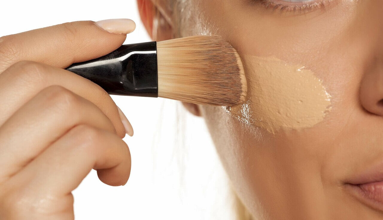 Woman applying liquid foundation.jpg