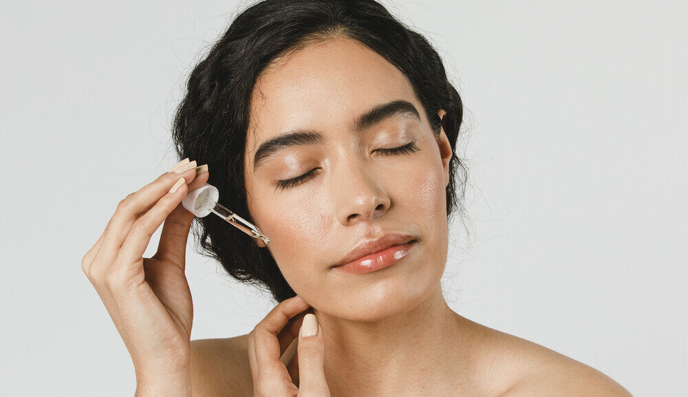 woman applying oil to her skin.jpg