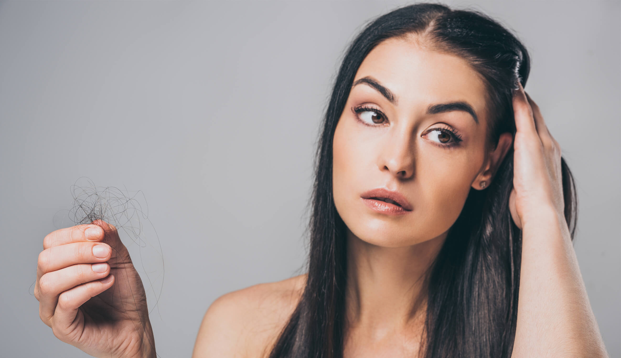 main_woman holding clumps of hair.jpg