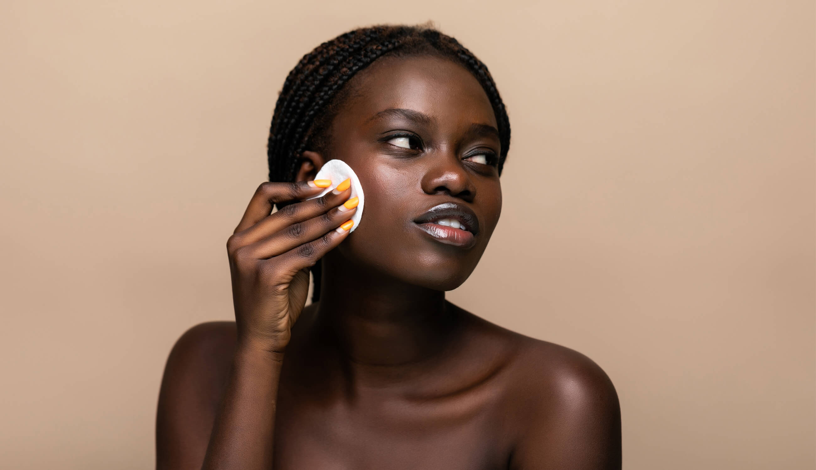 Main_woman removing makeup with sponge