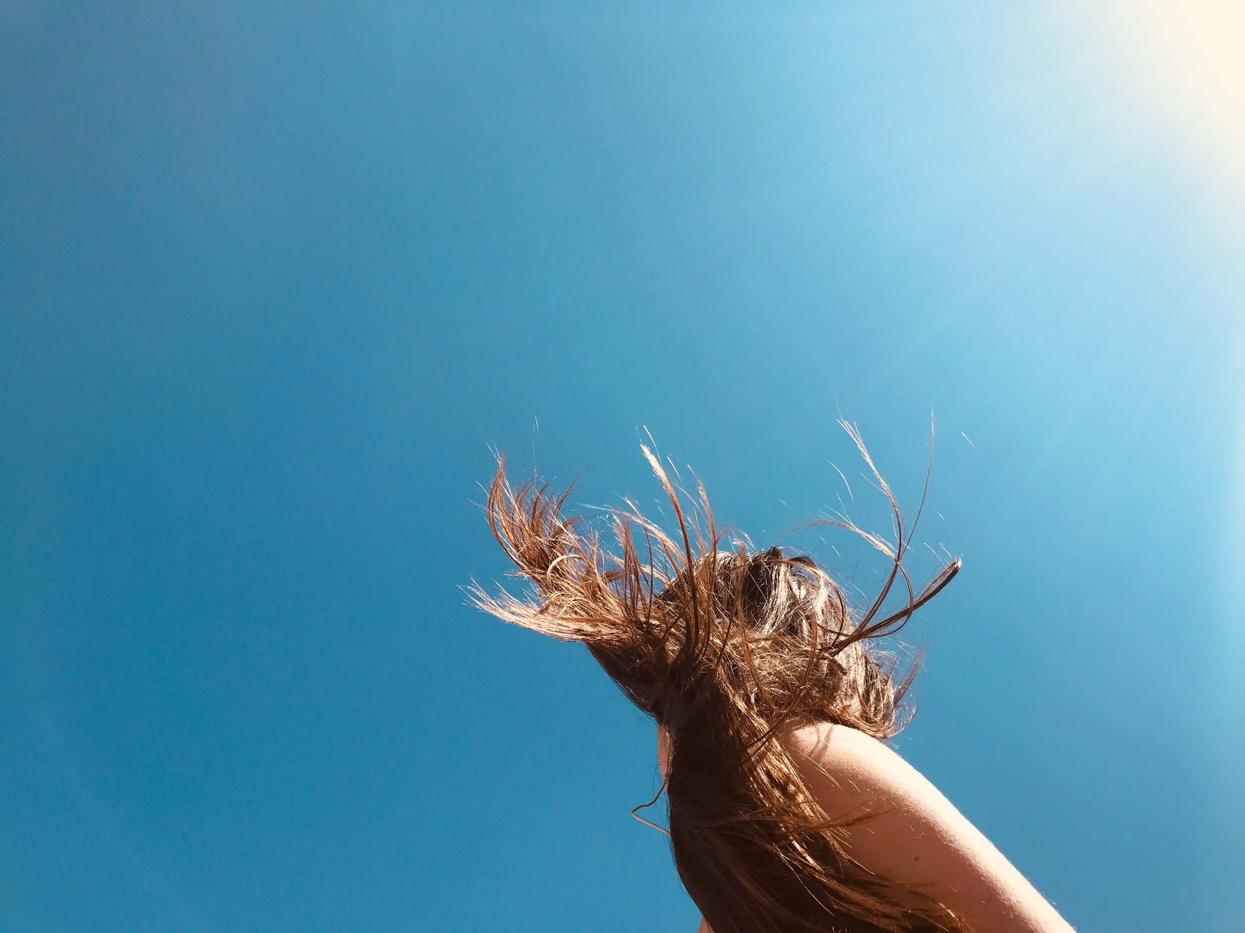 Woman with healthy hair posing in the sun